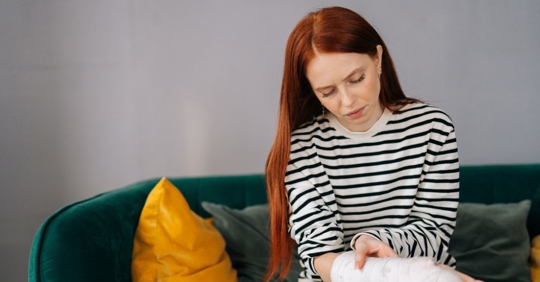 Woman looking at her injured arm