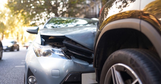 Close-up of two cars damaged in road traffic accident