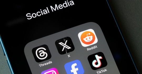 Assorted social media apps, including Threads, X, Reddit, Instagram, Facebook, and TikTok, are seen on an iPhone.